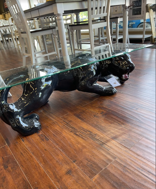 Our sleek Black Panther Coffee Table is the perfect way to add elegance and character to your living room. With a glossy black panther-shaped base and a clear glass top, it offers a blend of strength and beauty - Lifestyle Furniture