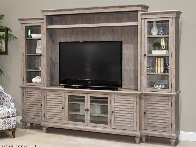 Made from pine solids and veneers with glass and wood doors, this convenient entertainment wall features sliding doors that provide access to media storage - Lifestyle Furniture